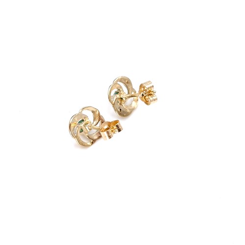 9 - Star Lot : A pair of twist set nine carat gold emerald and diamond stud earrings. Weight - 0.98 gram... 