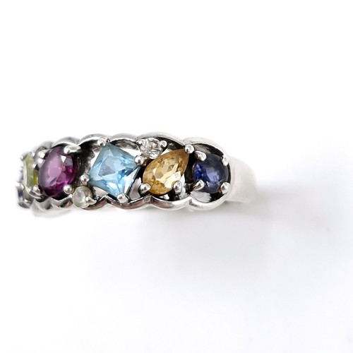 13 - A vari hue gemstone ring, with amethyst, aqua, citrine, sapphire etc  set in sterling silver. Ring s... 