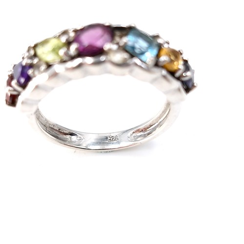 13 - A vari hue gemstone ring, with amethyst, aqua, citrine, sapphire etc  set in sterling silver. Ring s... 