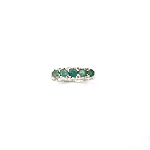 16 - A lovely five stone emerald ring set in sterling silver. Size - K. Weight - 1.6 grams.