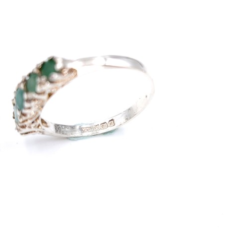 16 - A lovely five stone emerald ring set in sterling silver. Size - K. Weight - 1.6 grams.