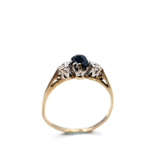 1213 - Star Lot: A very beautiful blue sapphire with two diamonds set in nine carat gold ring. Ring Size: M... 