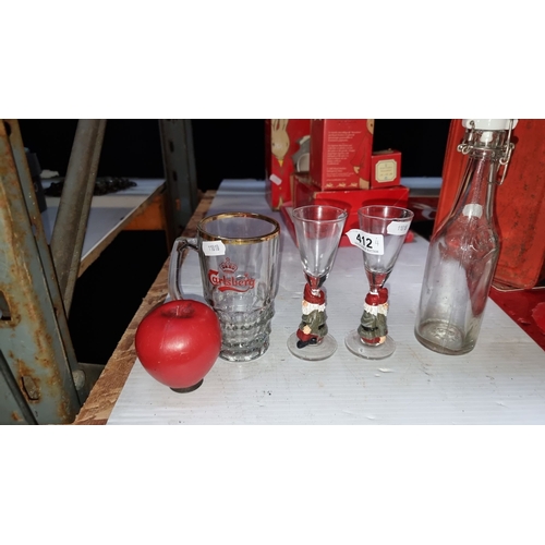 412 - Mixed lot includes a Carlsberg glass mug, two gnome-themed shot glasses, a red apple ornament, and a... 