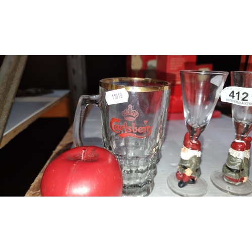 412 - Mixed lot includes a Carlsberg glass mug, two gnome-themed shot glasses, a red apple ornament, and a... 