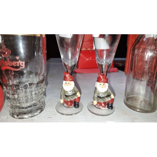 412 - Mixed lot includes a Carlsberg glass mug, two gnome-themed shot glasses, a red apple ornament, and a... 