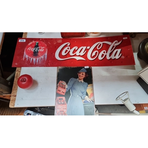 414 - Two Vintage Coca-Cola metal advertisement sign features a classic design, showcasing a woman in a bl... 