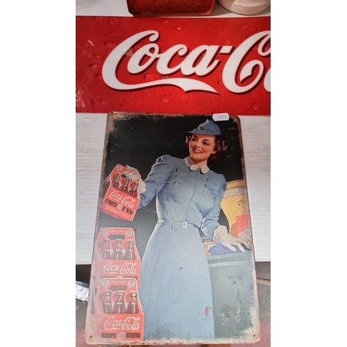 414 - Two Vintage Coca-Cola metal advertisement sign features a classic design, showcasing a woman in a bl... 