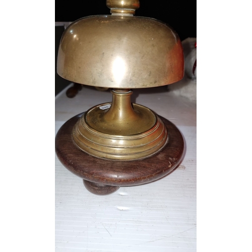 418 - A large and unusual antique Brass and wood desk bell, featuring a sturdy wooden handle and base. Cla... 