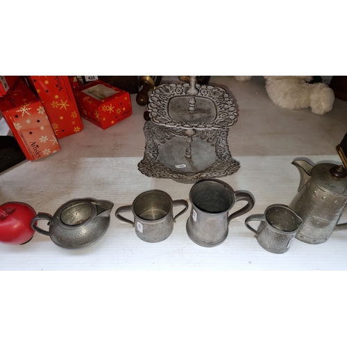 425 - A Talbot 1807 Pewter tea set with hammered finish includes teapot, creamer, sugar pot, and two-tiere... 