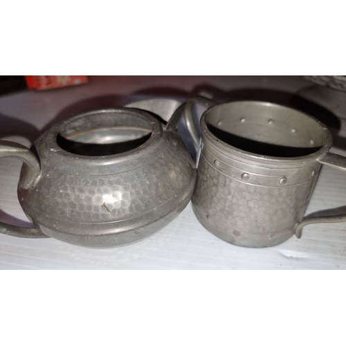 425 - A Talbot 1807 Pewter tea set with hammered finish includes teapot, creamer, sugar pot, and two-tiere... 