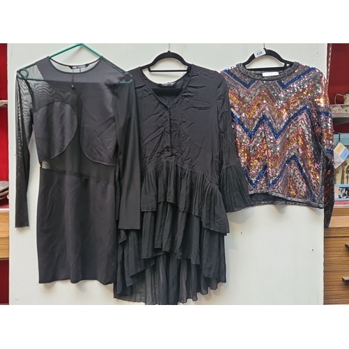 438 - Set of three garments includes a Zara black dress and two tops, one sequined, all size Medium.