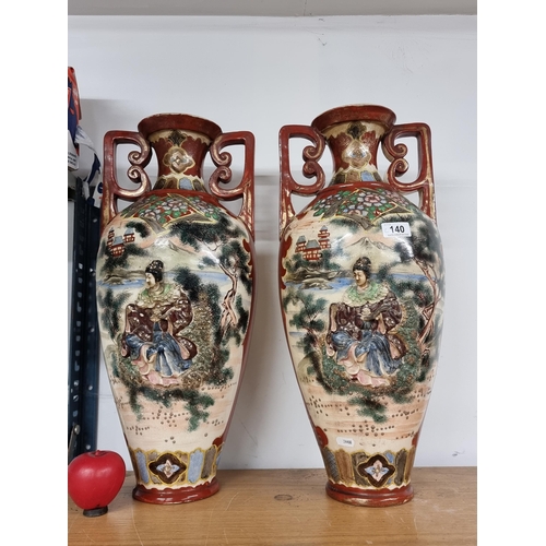 140 - Star Lot: An impressive large antique pair of Japanese satsuma style urn vases. Features moriage gla... 