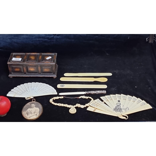 152 - A selection of eight vintage bone items all held in a lidded wooden box includes three fans, four le... 