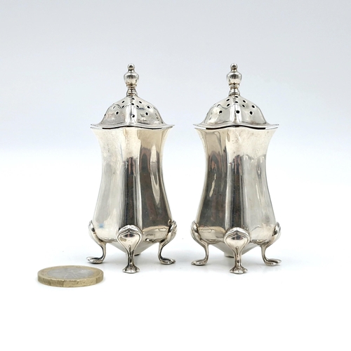 2 - Two silver pepperettes with attractive domed finial tops each set in four paw feet hallmarked Birmin... 