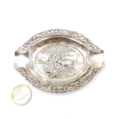 21 - A continental silver cigarette ashtray with intricate foliette detailing. Dimensions: 10 x 7.5 cms. ... 