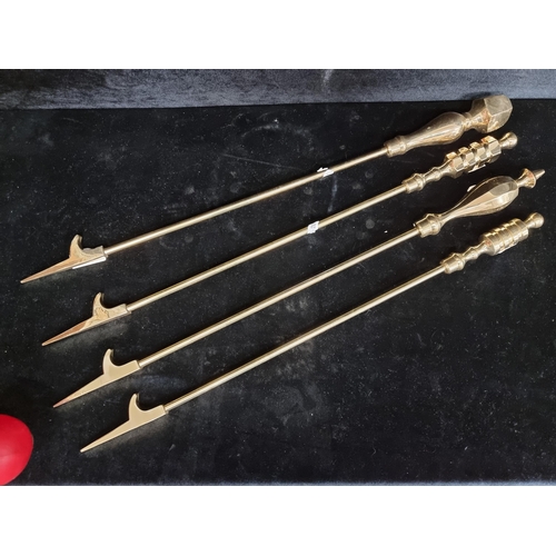 225 - Four solid polished brass fire pokers.