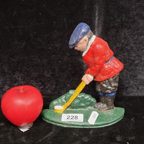 228 - A heavy cast metal door stopper in the form of a man playing golf.