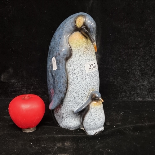 230 - A super cute and wholesome tall ceramic figure in the form of penguins. A chick nestled against its ... 