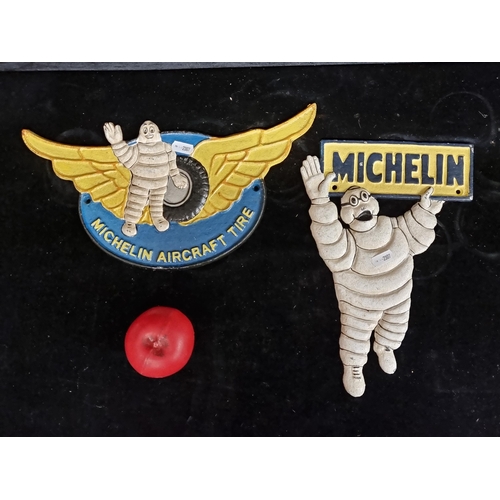 244 - A heavy cast metal 'Michelin' wall plaque advertising featuring the Michelin man. Along with another... 