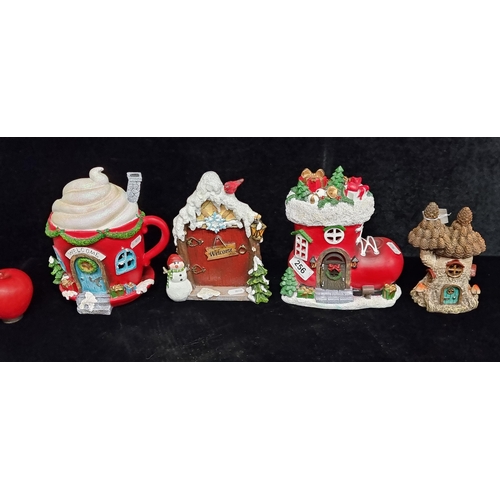 256 - Four whimsical Christmas items including a cup cake and boot house and a fairy door. All brand new f... 