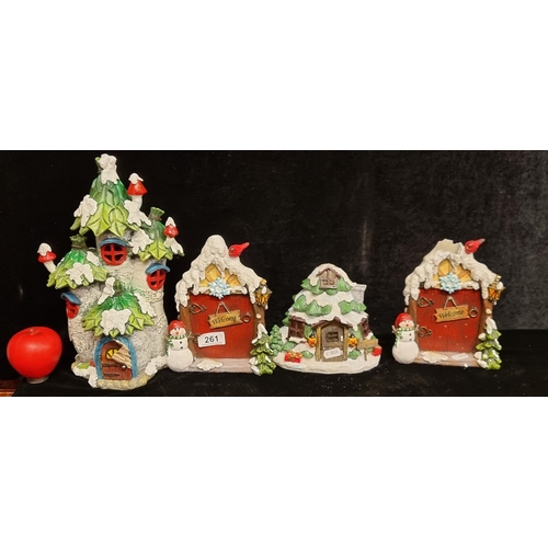 261 - Four Christmas decor items including two charming fairy doors with snowmen, a snow topped tree house... 