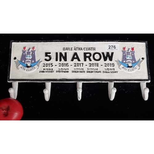 276 - A cast iron wall mounted set of coat hooks celebrating Dublin's '5 in a Row' GAA wins.