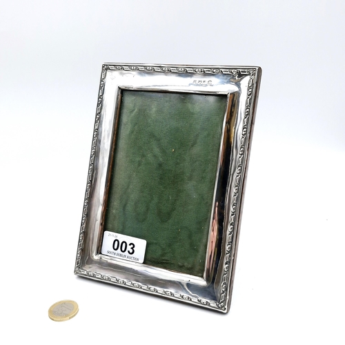 3 - A glazed sterling silver photograph frame set with attractive foliette detailing to rim. Internal di... 