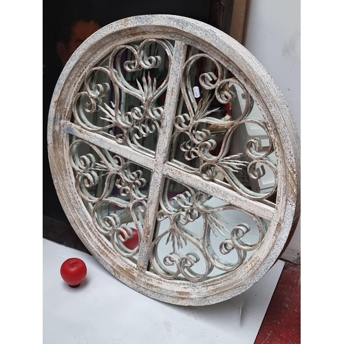 304 - A gothic quadrant circular mirror featuring scrolled metal work. Indoor or outdoor.