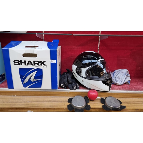 331 - An as new Shark Vision R Carbon helmet in black, size large. In its original box. RRP €169.00 with a... 