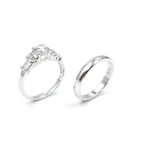 38 - Two sterling silver promise  rings one with cubic zirconia setting. The other a circular ring both s... 