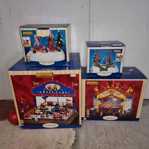 388 - Four vintage Lemax light up carnival and Christmas decorations including miniature bumper cars.