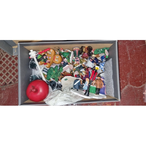 394 - A box containing a large quantity of vintage Lemax figurines including Christmas market stall pieces... 