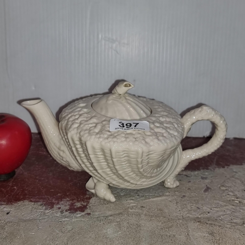 397 - A handsome antique belleek or belleek style shell tea pot. Dont see a mark on it. In good order.