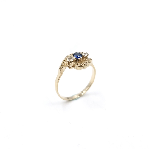 53 - A pretty nine carat gold twist set sapphire ring with gemstone detailing. Size - J. Weight - 1.67 gr... 