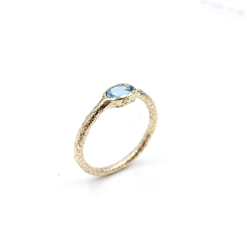 54 - A blue topaz nine carat gold ring. Size - O 1/2. Weight - 1.5 grams.