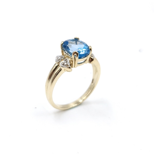 57 - Star Lot : A beautiful nine carat gold fine blue large topaz and diamond stone ring. Size - M. Weigh... 