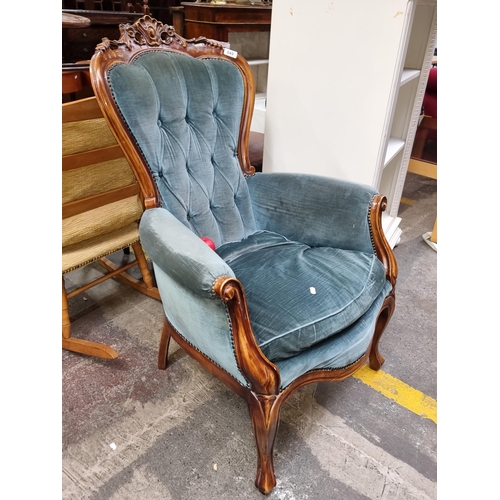 649 - A lavish Victorian style armchair features button back, teal blue upholstery with brass studs. Mahog... 