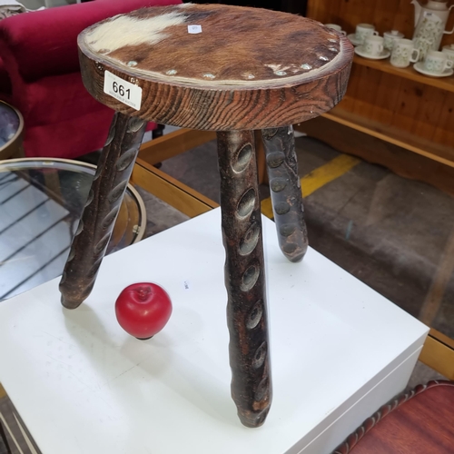 661 - A wonderful farmhouse tripod milking stool with cowhide seat.