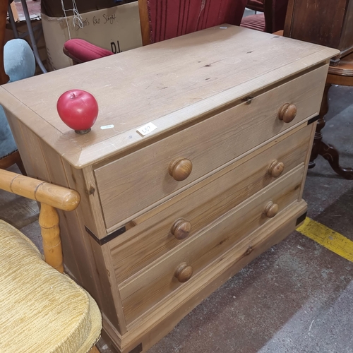 667 - A well crafted and nicely sized sol pine chest of drawers featuring three pull out drawers with bun ... 