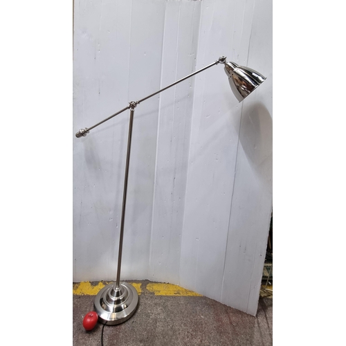 692 - A tall articulated floor standing reading  lamp in brushed chrome. In nice clean condition. Good to ... 