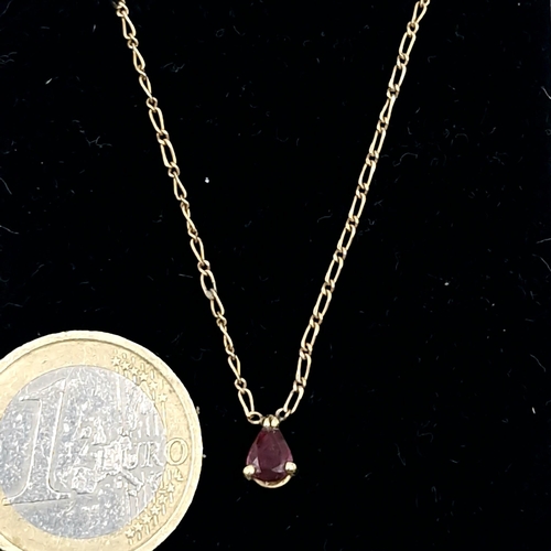 515 - Star Lot : A nine carat gold ruby pendant necklace. Length - 40 cms. Weight - 1.85 grams. Boxed.