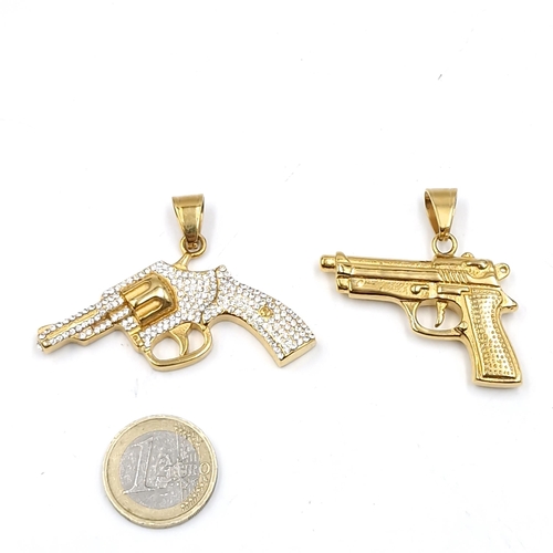 516 - Two gold toned pistol pendants - a double sided example (Weight - 20.8 grams). Together with a gem s... 