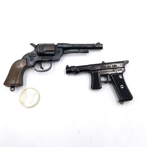 524 - Two miniature metal pistols. A Luger marked 'Calvin Hill'. Weight - 38 grams. And a Colt pistol mark... 