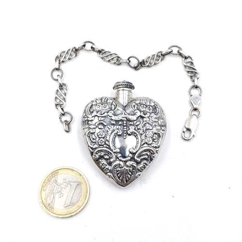 534 - A silver heart shaped perfume bottle with stopper together with a bracelet with lobster clasp.