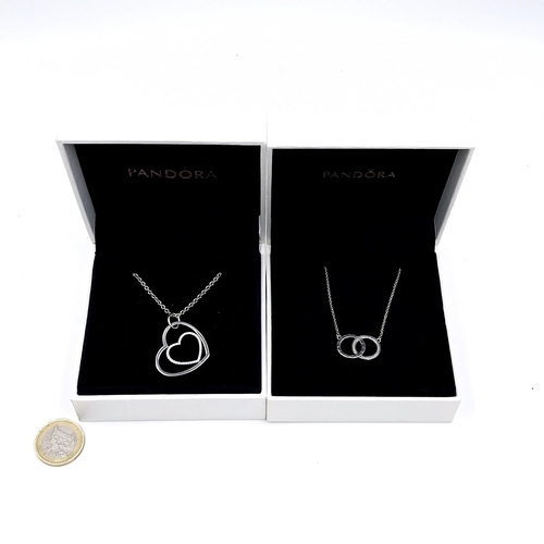 573 - Two necklaces. A double ring Pandora necklace. Length - 40 cms. Together with a double heart pendant... 