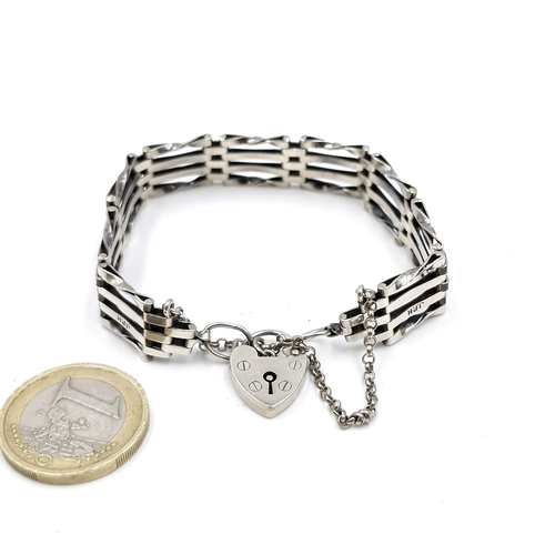 580 - A sterling silver gate bracelet set with pad lock clasp and safety chain. Weight - 16 grams.