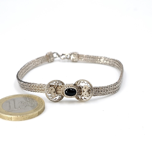 592 - A very pretty sterling silver bracelet with central cabochon stone mount. Weight - 8.18 grams.