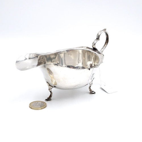 605 - A sterling silver sauce boat with three paw feet hallmarked Birmingham - 1918. Weight - 105 grams.