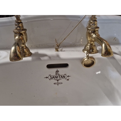 843 - Antique porcelain sink by B.C. Sanitan, featuring brass taps. Classic design with an ornate logo, mo... 