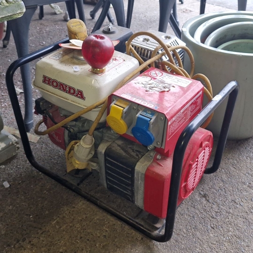 856 - Honda site generator EG 1900X, portable, features dual voltage outputs. With 110v extension chord.